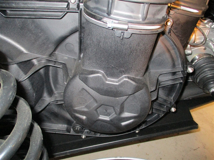 Close-up view of an off-road vehicle's CVT clutch housing and intake system with visible clamps and bolts