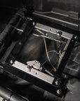 PRP seat slider and mount kit installed in a Can-Am vehicle, showing metal frame and adjustment mechanism