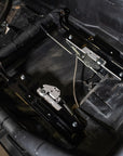 Installed PRP seat slider kit in a Can-Am, showing mounted rails and adjustment cables inside the vehicle