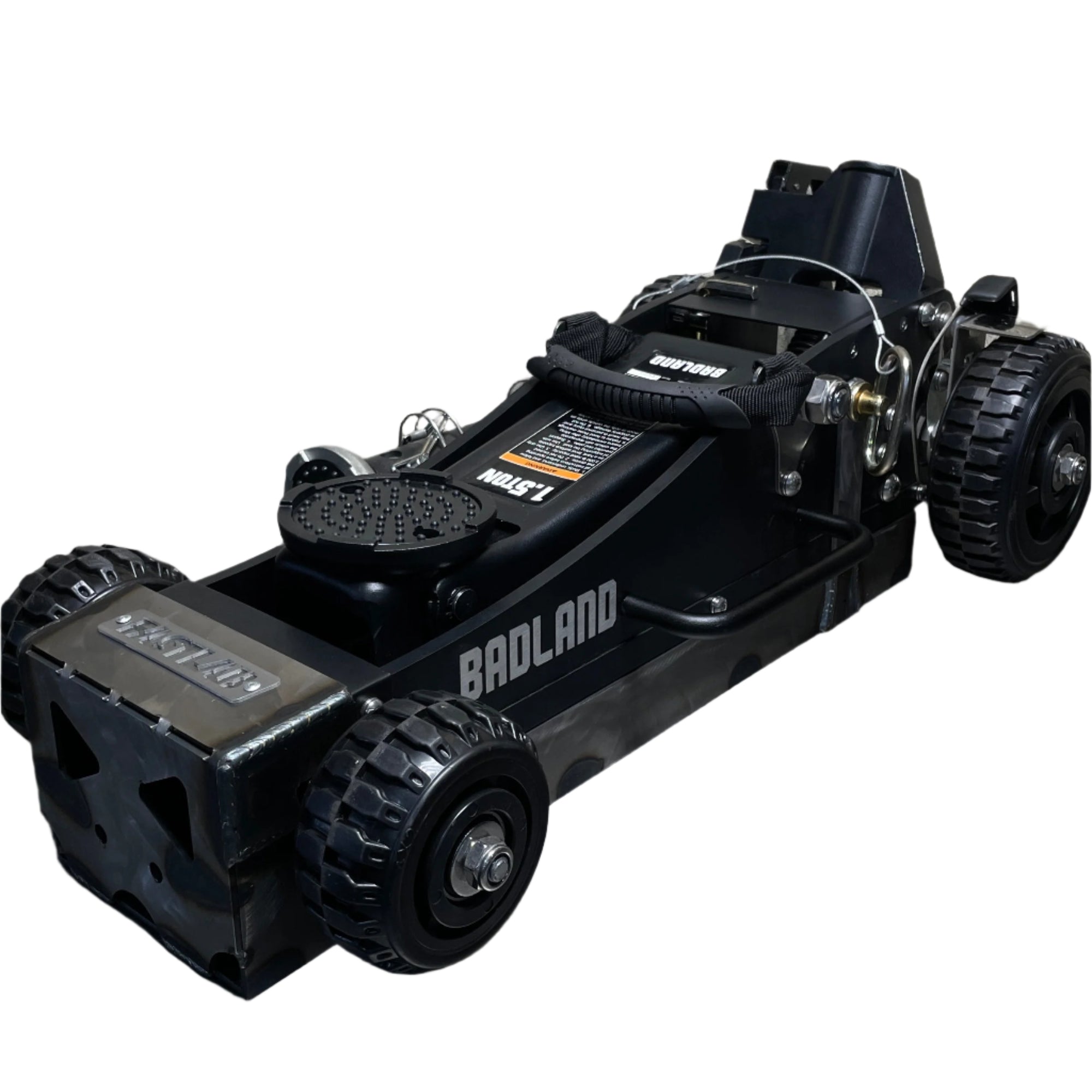 Black hydraulic floor jack on a concrete floor with a gray brick wall in the background