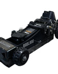 Black hydraulic floor jack on a concrete floor with a gray brick wall in the background